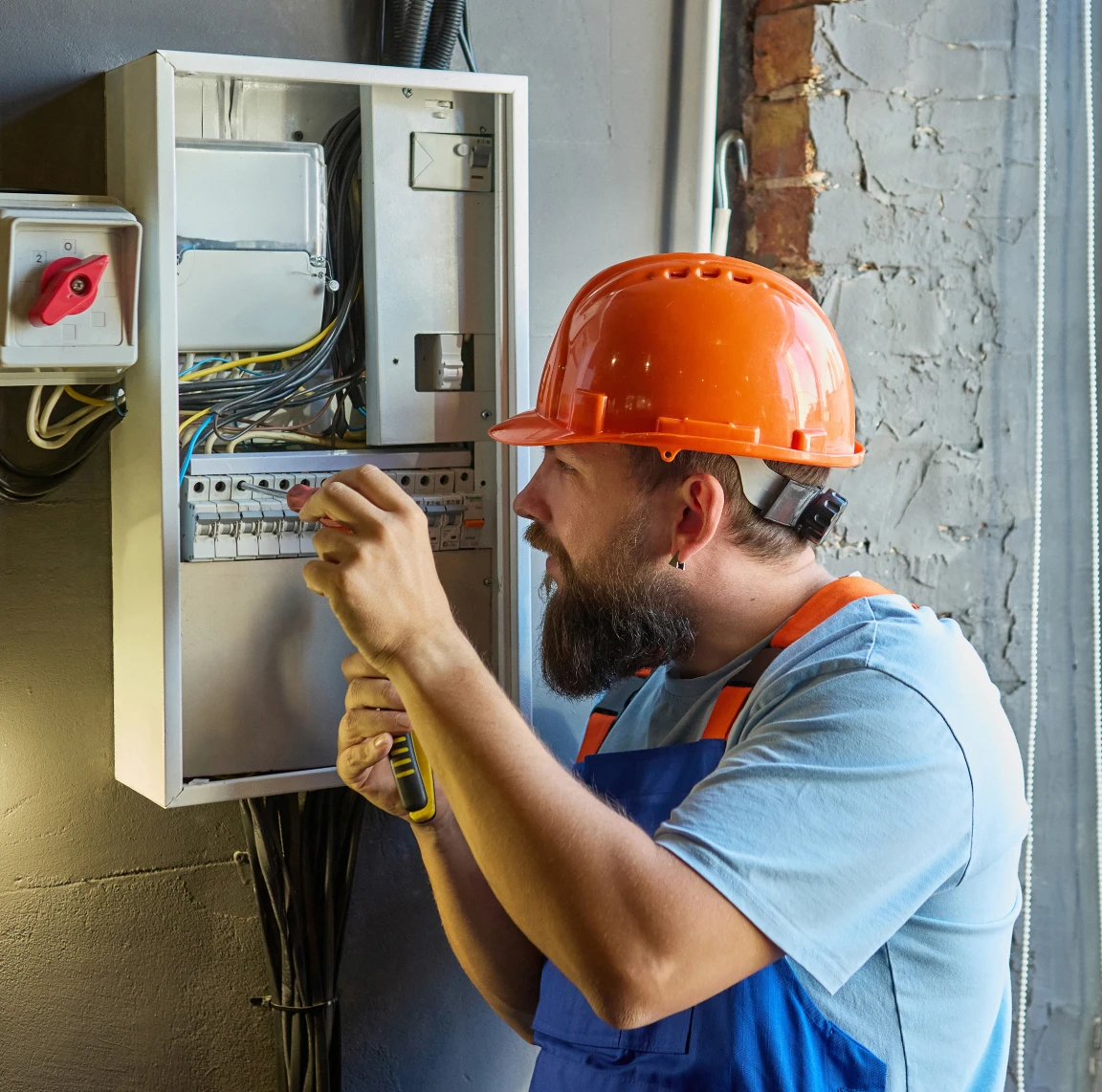 Electrician working on electrical panel