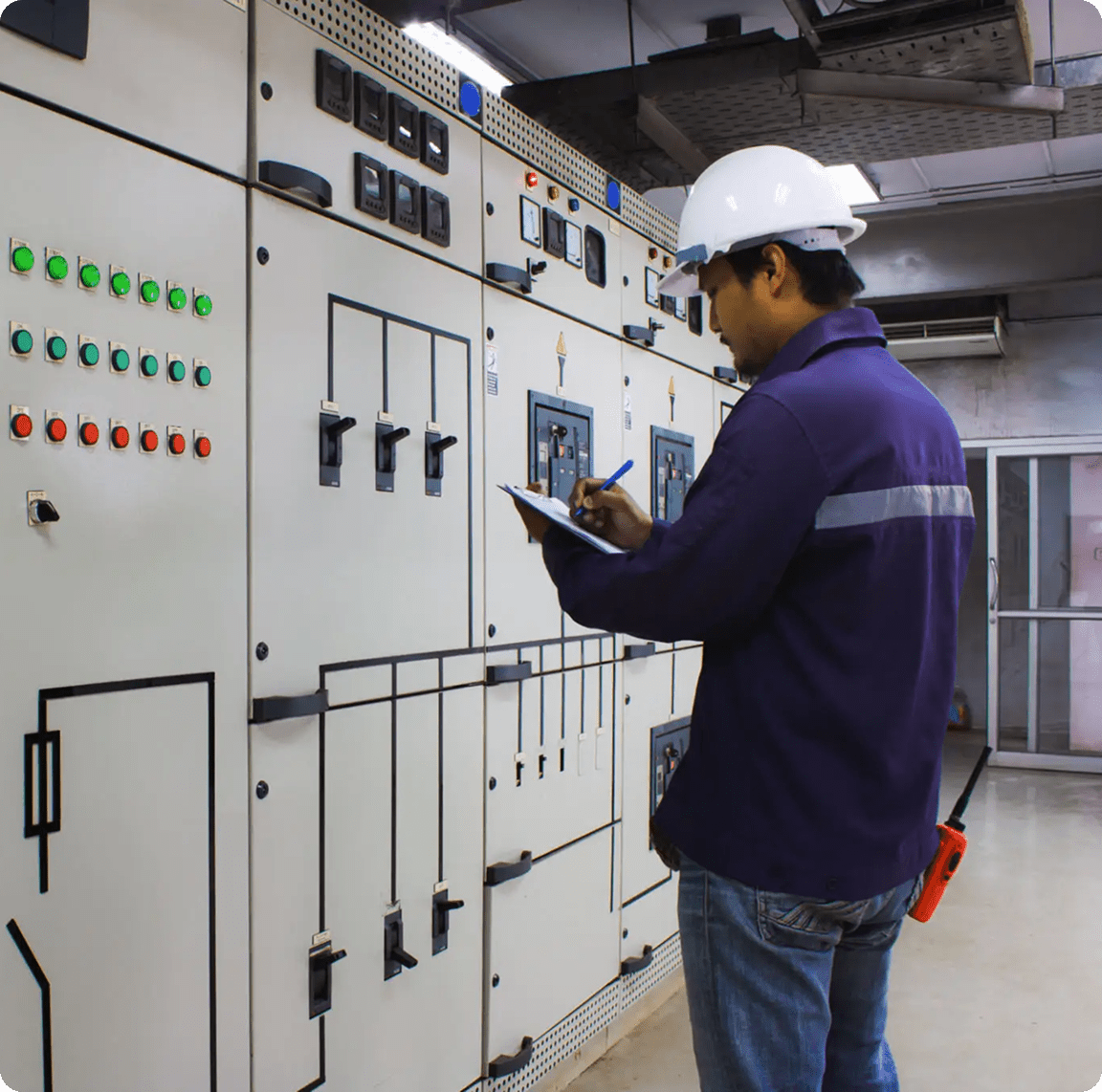 Worker checking equipment in industrial setting