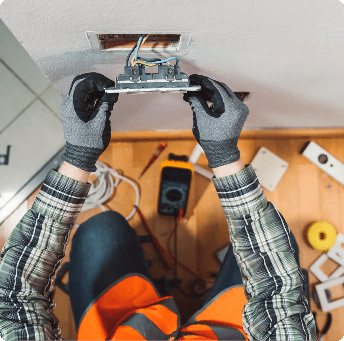 Electrician wiring a socket on wall