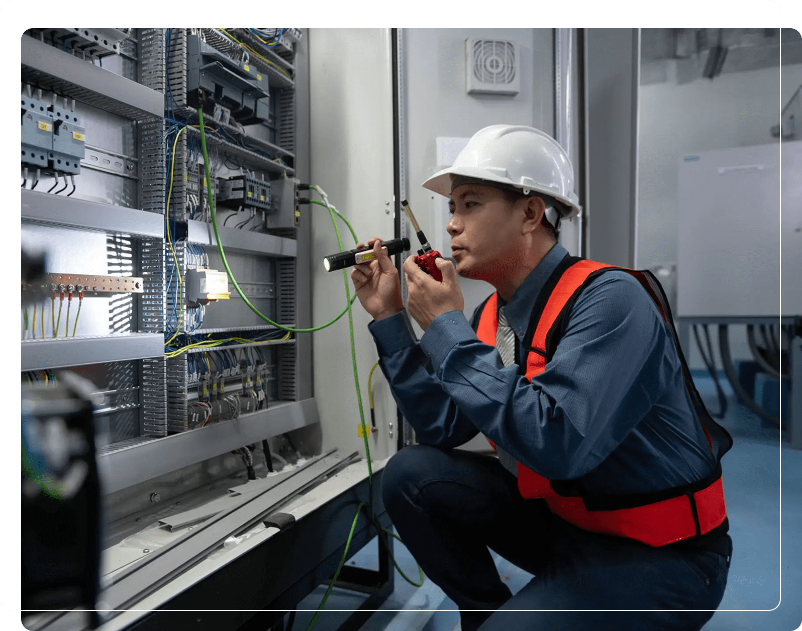 Worker with hard hat checking wiring